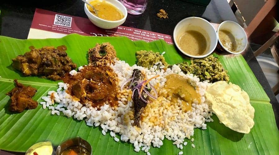 Traditional Kerala vegetarian meal served on a banana leaf in Dubai.