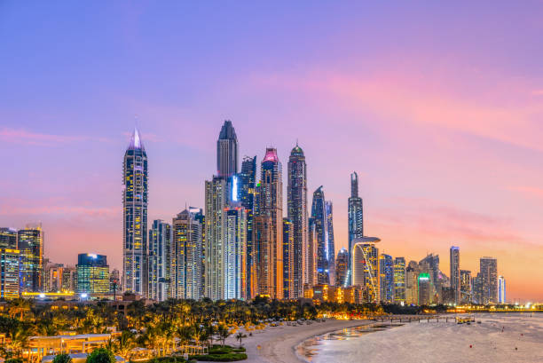skyscrapers of the marina illuminated by twilight, view across bay